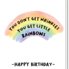 Voorkant wenskaart met een regenboog met de tekst: you don't get wrinkles you get little rainbows